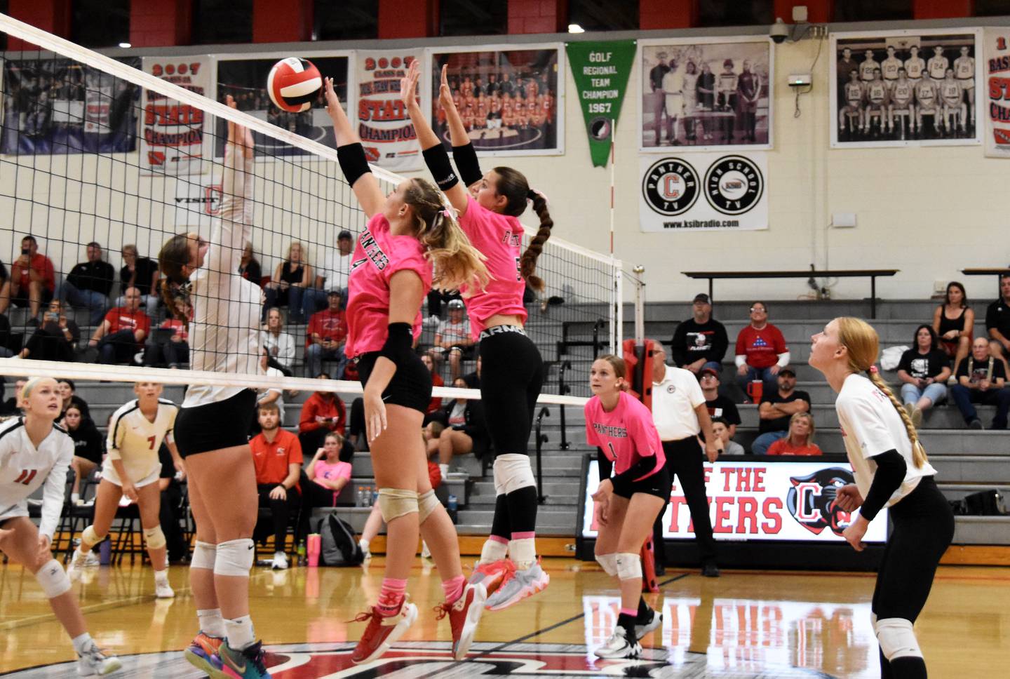 Creston junior Ella Turner (No. 4) gets a hand on a Cyclone attack, earning a solo block. Teammate Braylee Pokorny jumps with her. Pokorny also had a solo block on the night.