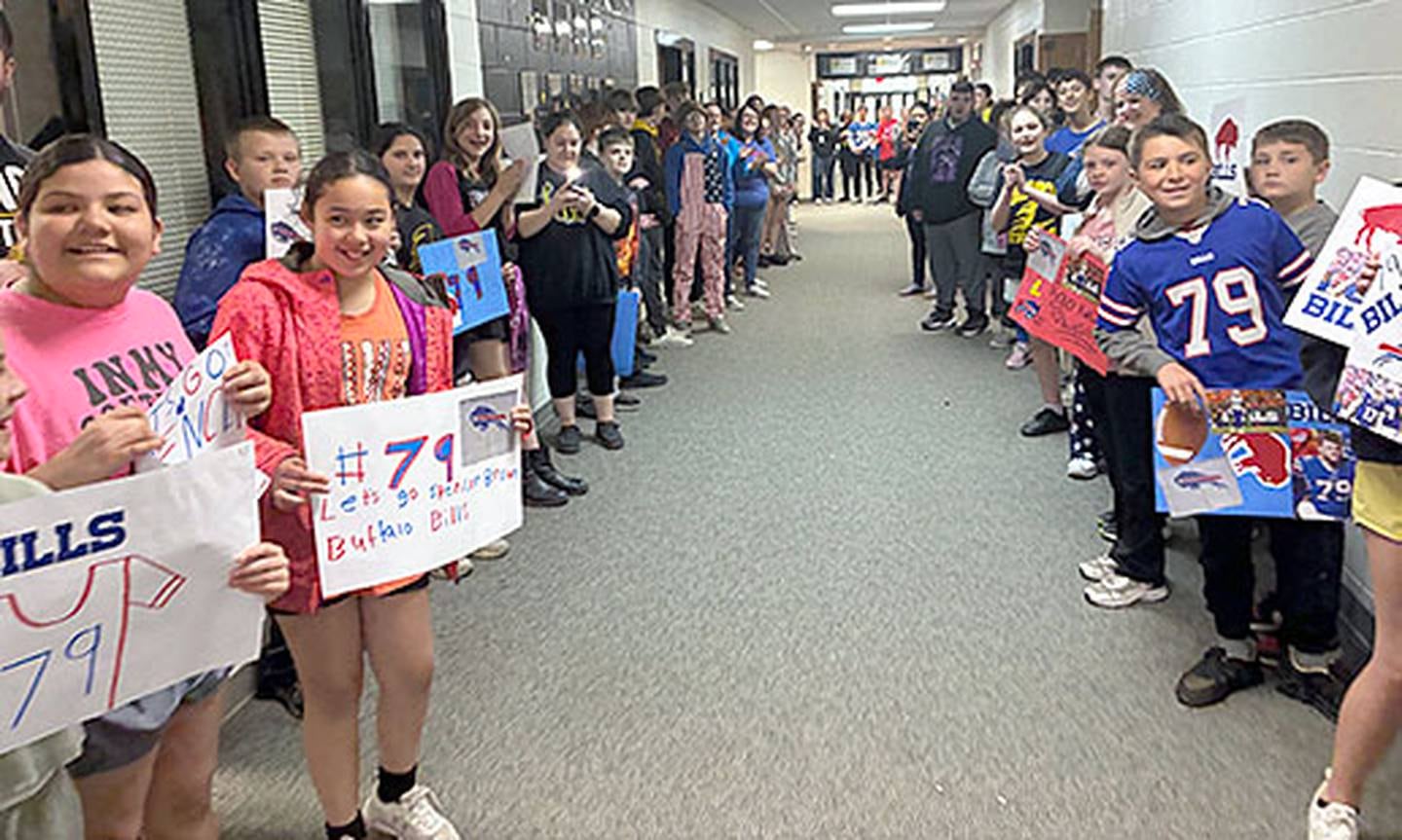 Students eagerly await Spencer Brown's walk through the hallways Friday, with many signs made for his visit.