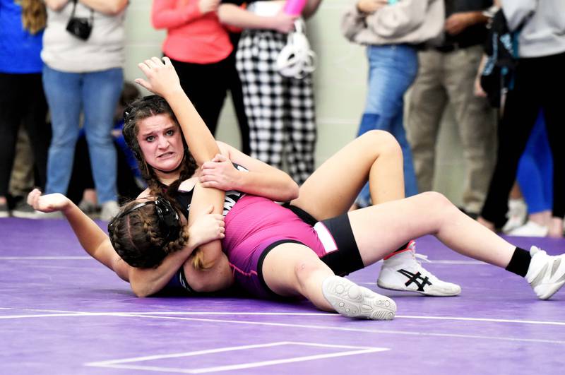 Cheyenne Dike (140) leans back, pinning Bailey Lillard of S.W.A.T. in the second period to advance to the finals. Dike got second in her weight class.