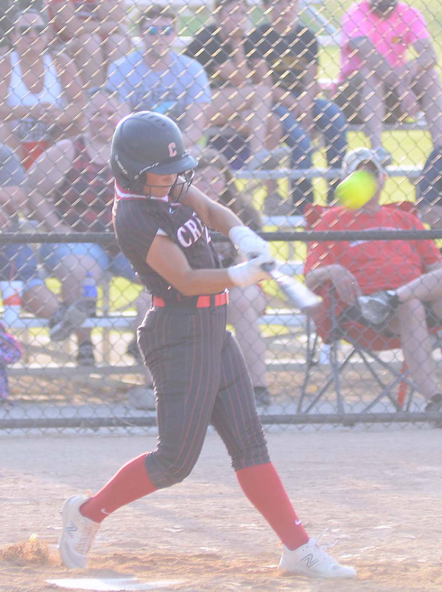 Jersey Foote of Creston connects with one of the longest home runs in Panther Field history in the Panthers' 12-10 victory in game one Monday. The ball sailed high over the trees past the left field fence, for her third homer of the season.