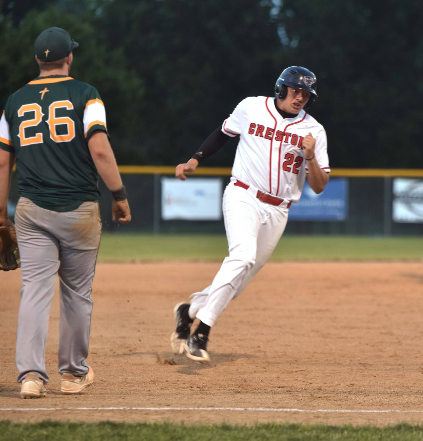 Courtesy runner Brayden Schoon rounds third base before scoring a run for Tom Mikkelsen on a hit by Mattias Schultes.