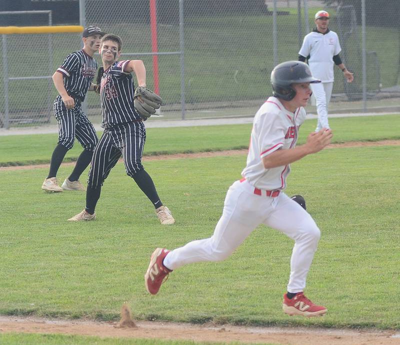 Clarke pitcher Bryce Giza throws to first base as Creston's Tyler Riley runs after a sacrifice bunt. Giza pitched 6 1/3 innings in Clarke's 6-1 victory.