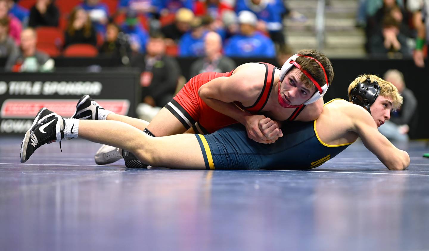 Lane Travis traps the arm of Jared Glendening behind his back Thursday in the second round of state wrestling. Glendening of Burlington Notre Dame won the bout 9-6 in sudden death.