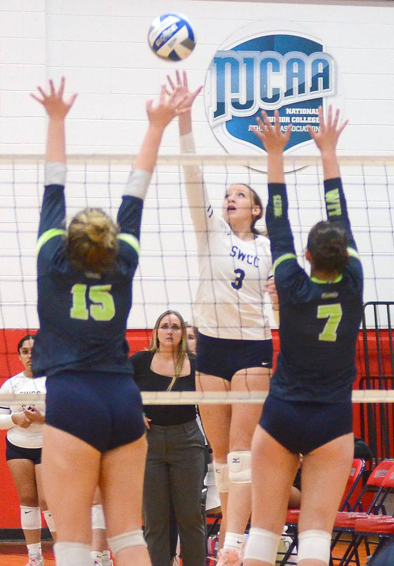 Southwestern freshman Audrey Boban (3) of East Mills sends a kill through the block attempt of Western Iowa Tech's Emily Crites (15) and Kaira Willits (7) during Wednesday's match.