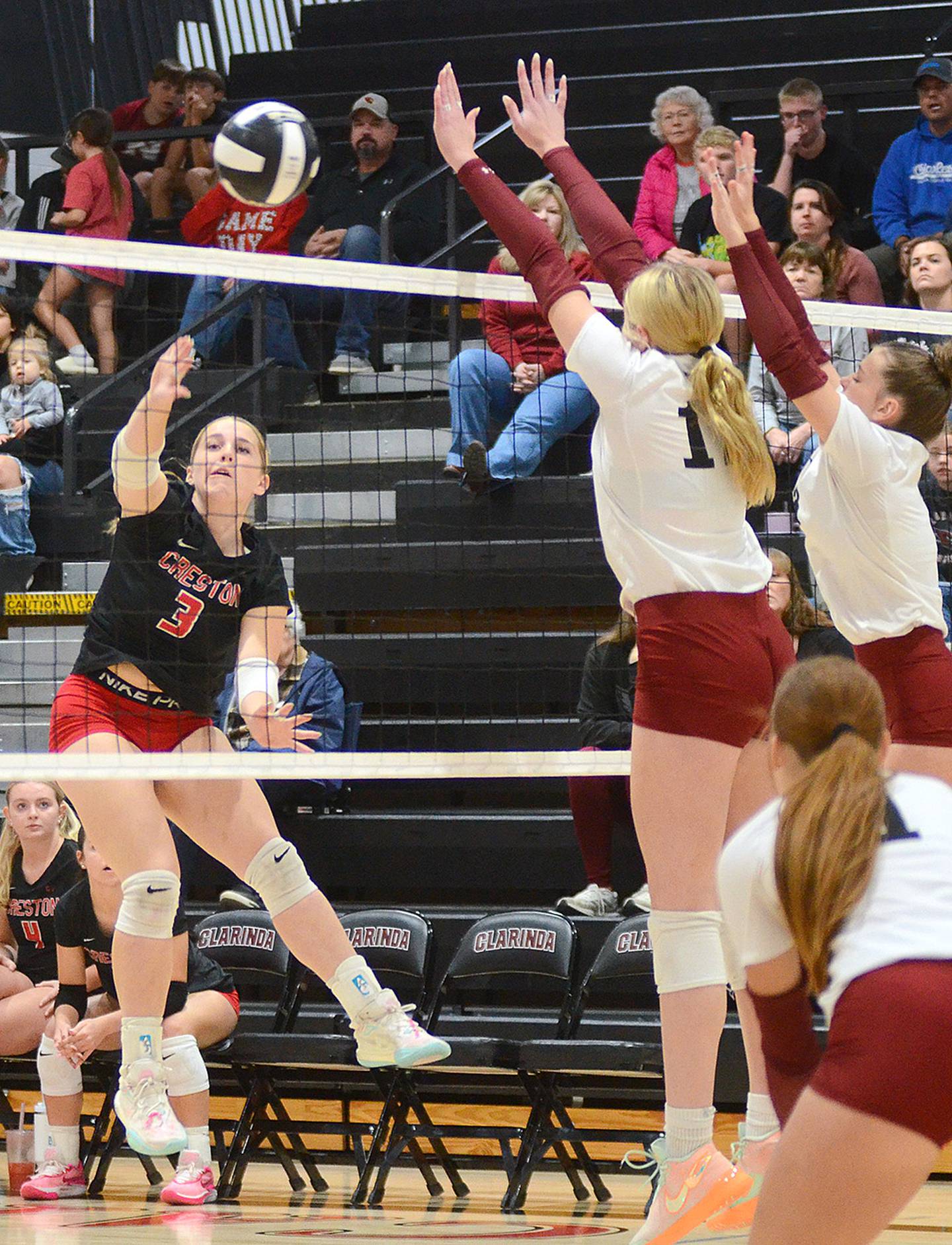 Jaycee Hanson of Creston sends one of her 13 kills into the Clarinda court past 6-1 middle blocker Carsen Wellhausen (12).
