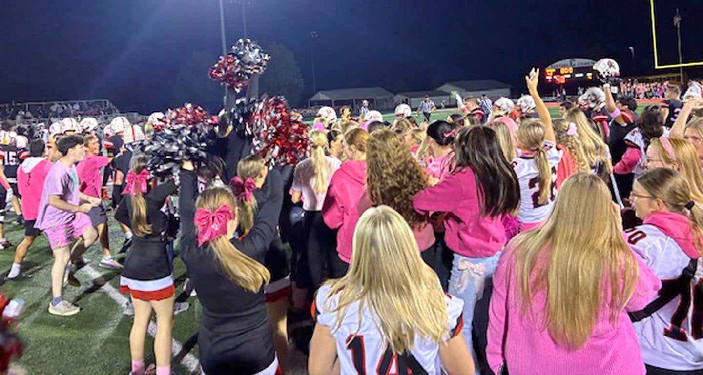 Creston students join players in a postgame celebration on the field after the Panthers defeated Greene County, 42-35.