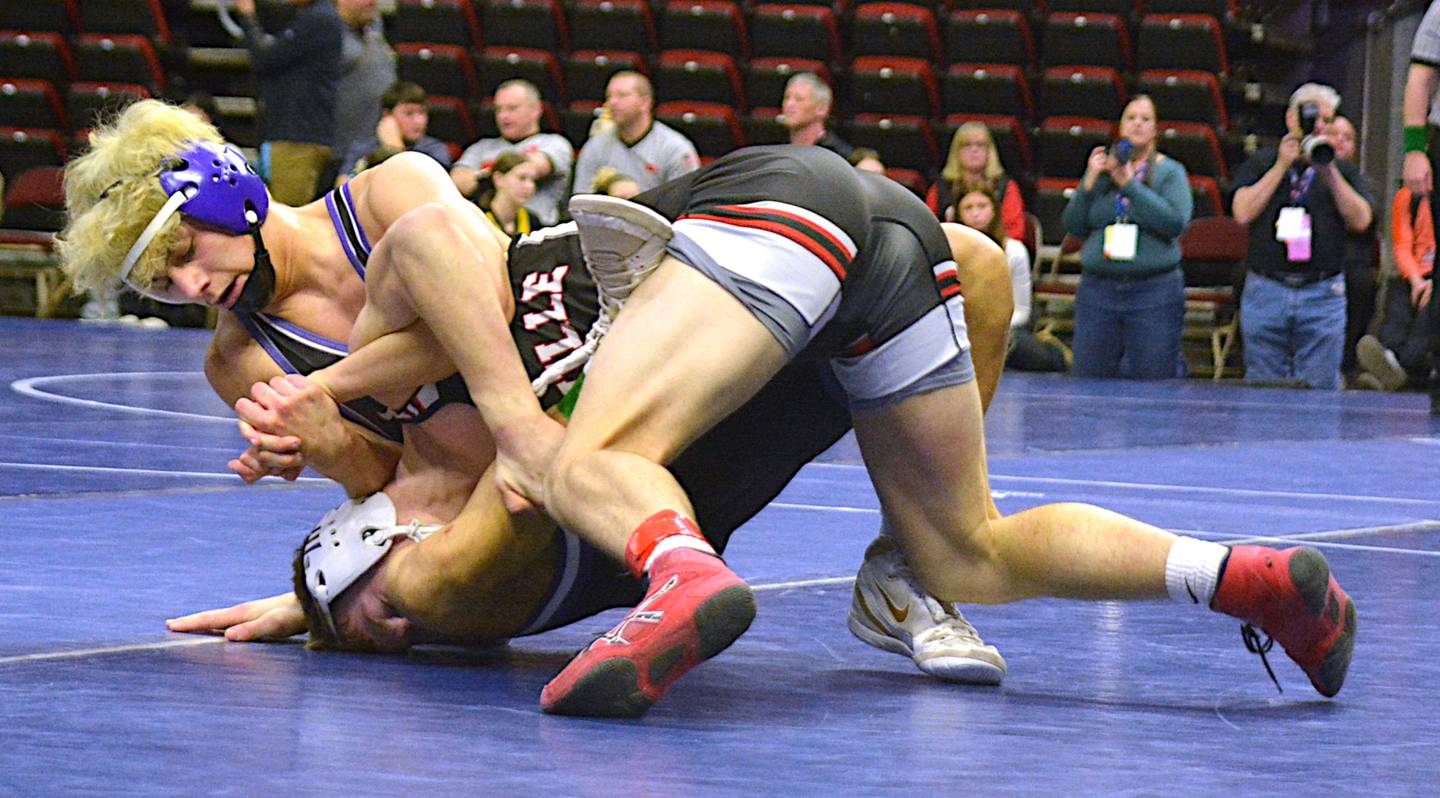 NV senior Keyin Steeve looks for a tilt opportunity against Riceville's Chance Christensen in their 144-pound opening match at state.