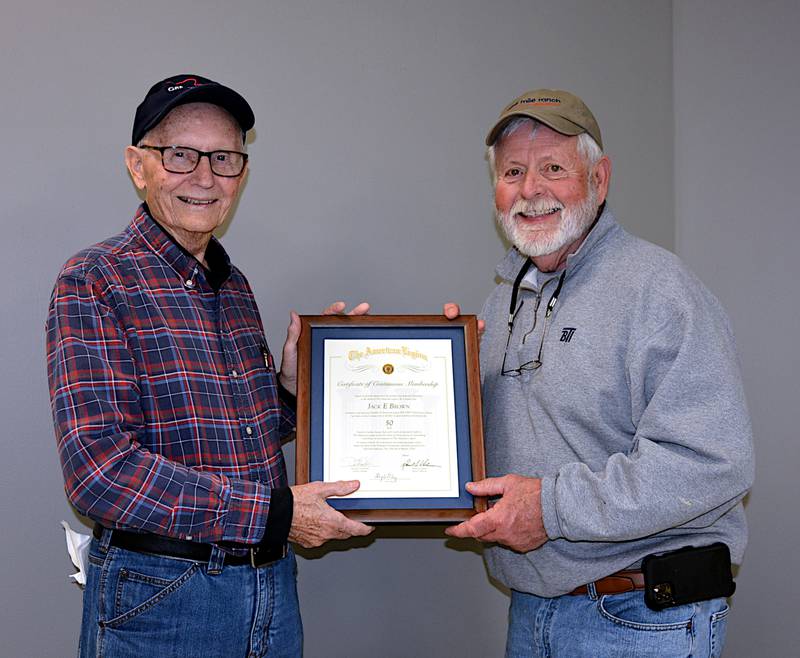 Jack Brown, left, receives a plaque, presented by Gary Handley, for his 50 years in the American Legion organization. The presentation was made Friday, March 22 at the Head-Endres Post 265 fish fry at the Adair County Health and Fitness Center.