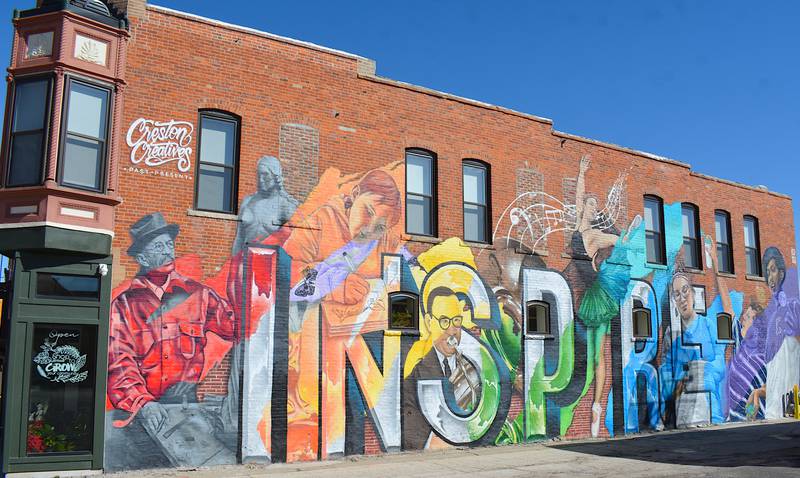 The "Inspire" mural on Cherry Street was noted as an "Insta-worthy Mural" in the 2025 Travel Iowa booklet.