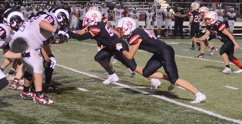Defensive linemen Ethan Holliday (48), Hayden Levine (50) and Blake Hayes break on the snap against Greene County Friday night. The Panthers seek their second win in a trip Friday to Perry.