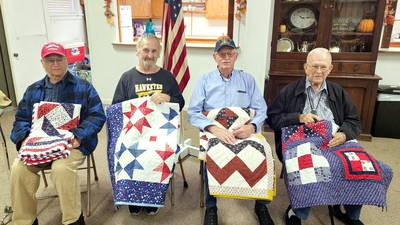 Four who served accept quilts