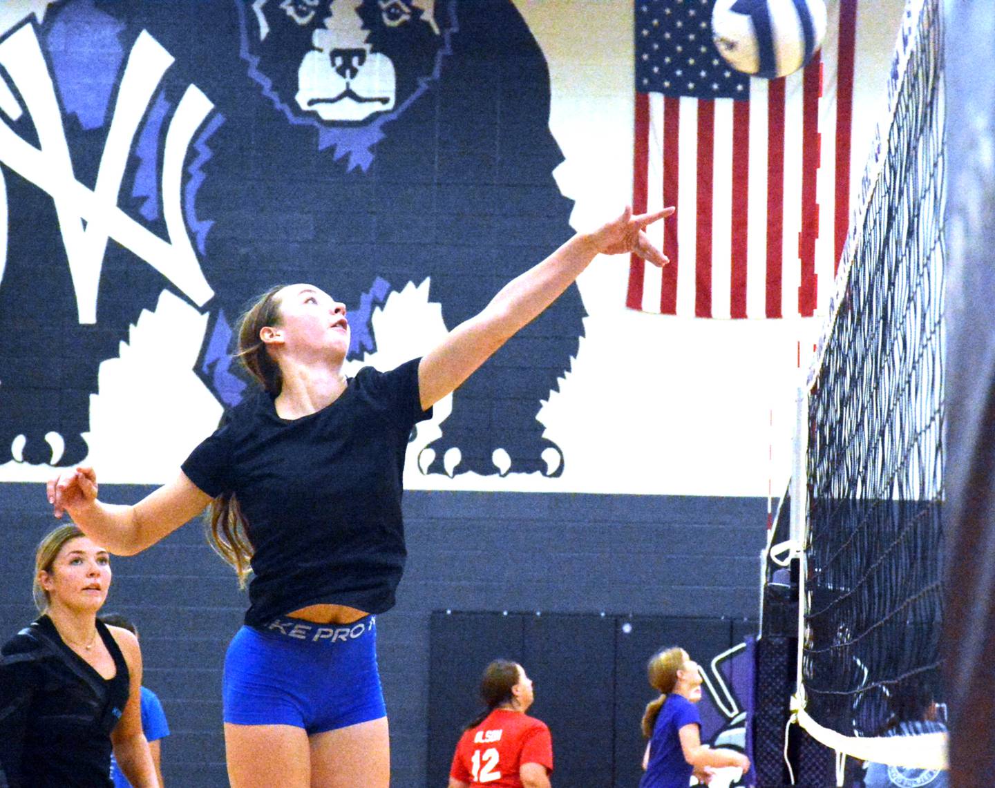 NV/OM senior Kylie Nelson returns a ball over the net in a recent Wolverine volleyball practice. The team scrimmages CAM Aug. 22 at home and hosts Atlantic Aug. 28 for their first match.