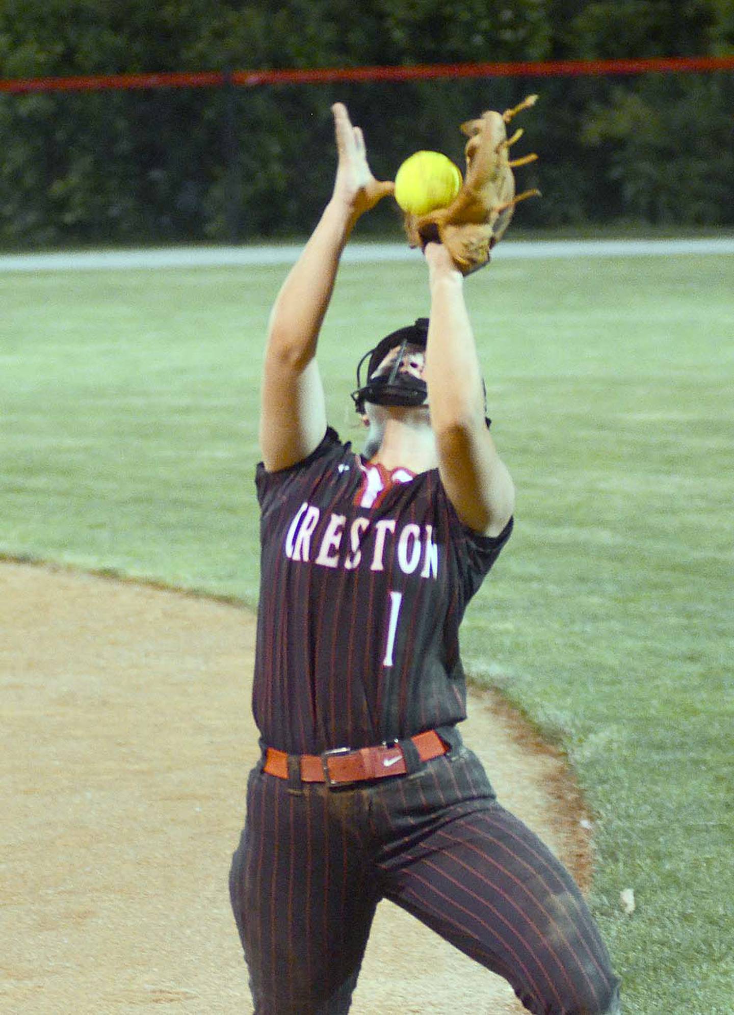 Creston senior second baseman Sophie Hagle catches a foul popup near the fence during Monday's home doubleheader against Atlantic.