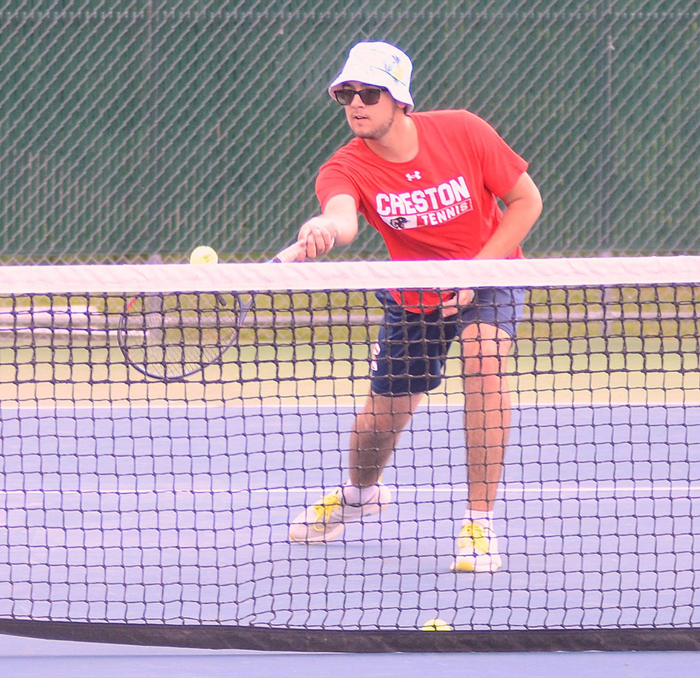 Wesley Wires of Creston returns a shot at the net against Clarke Friday. Clarke's Luke Wade edged Wires in No. 2 singles, 8-6.