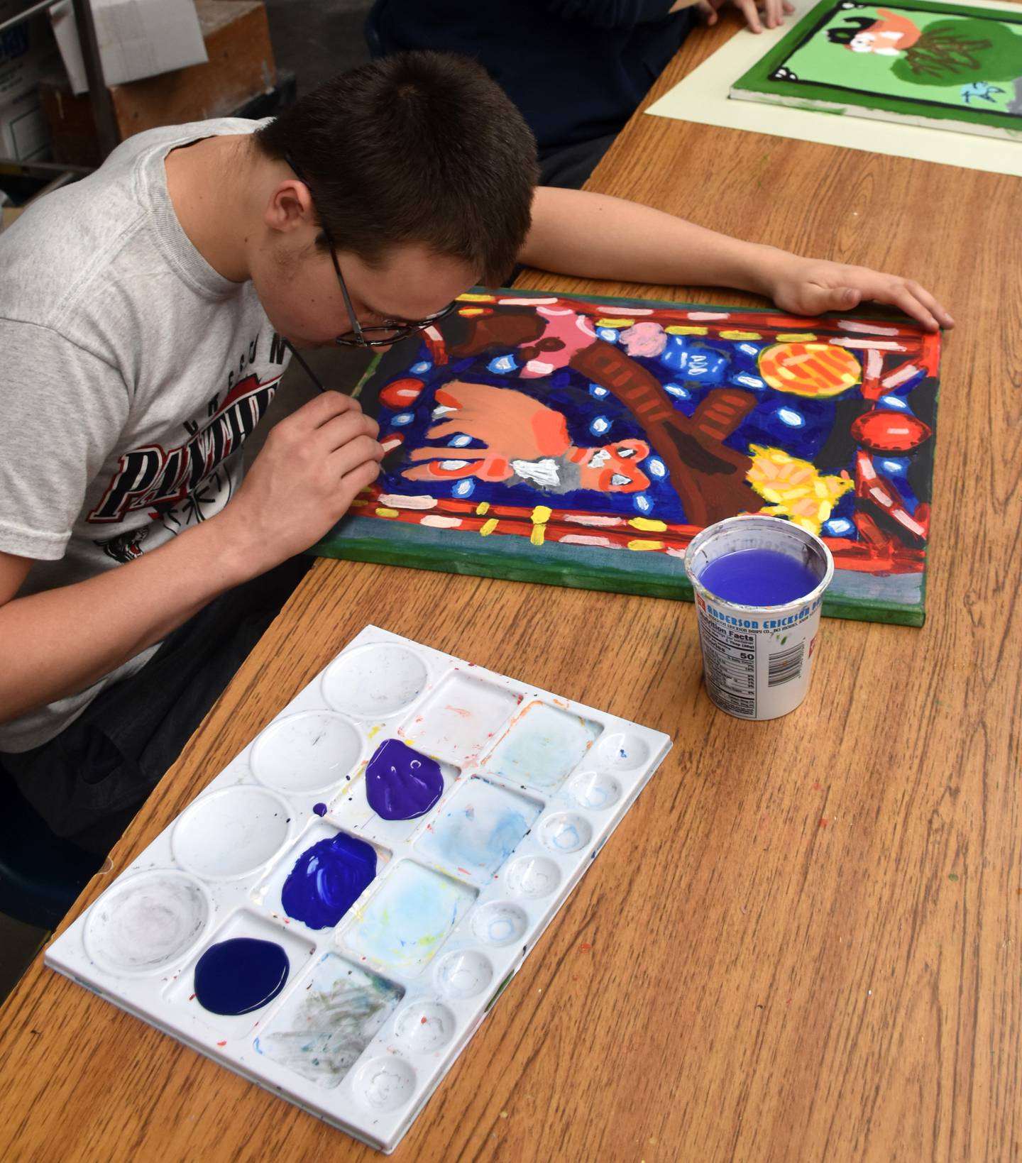 Junior Avery Graham puts finishing touches on his art.