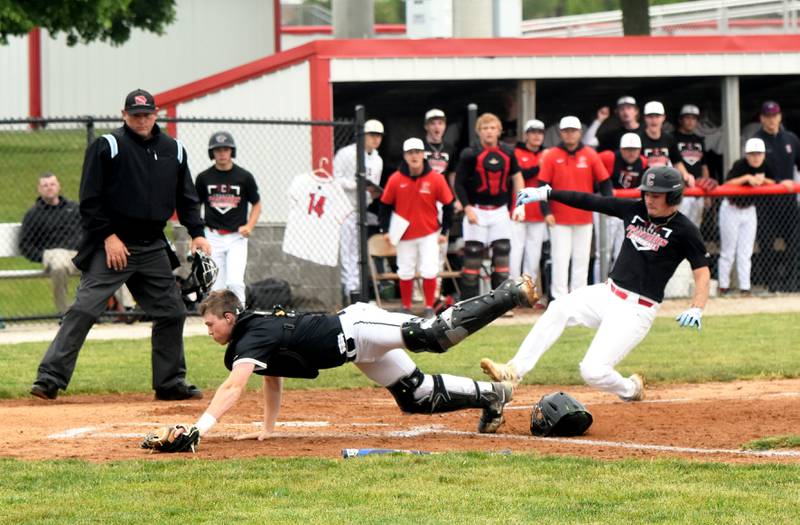 Creston senior Camden Smith slides home as the Winterset catcher misses the throw to home plate.