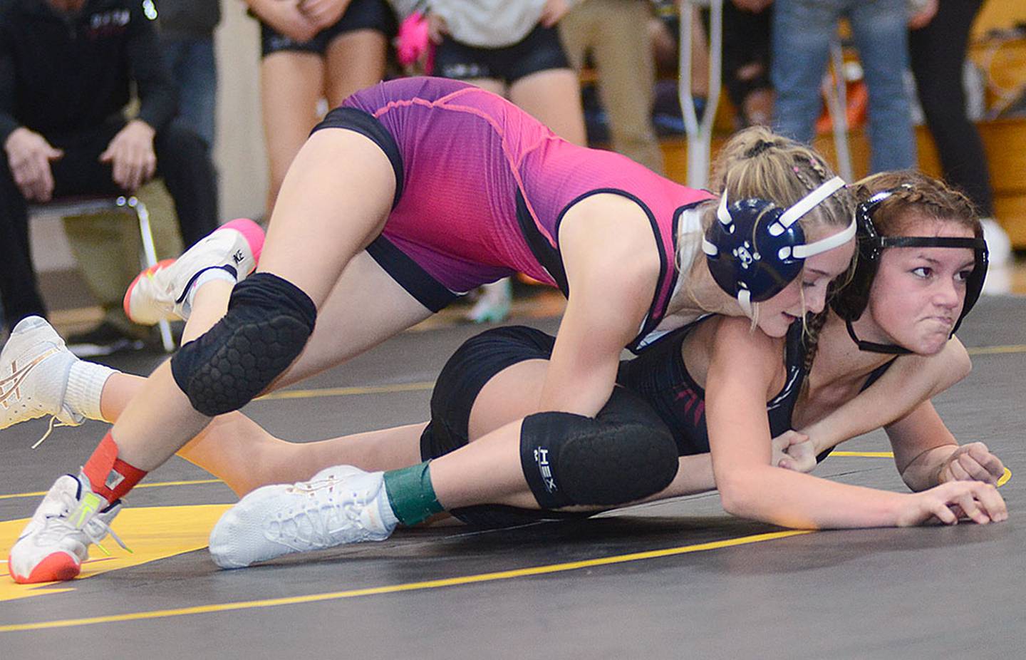 Highway 34's Quynn Foster works in the top position against S.W.A.T.'s Addison Herr during their match Thursday in Atlantic. Foster won by fall in 5:52 and placed second at 105 pounds in the Riverside Invitational on Friday.