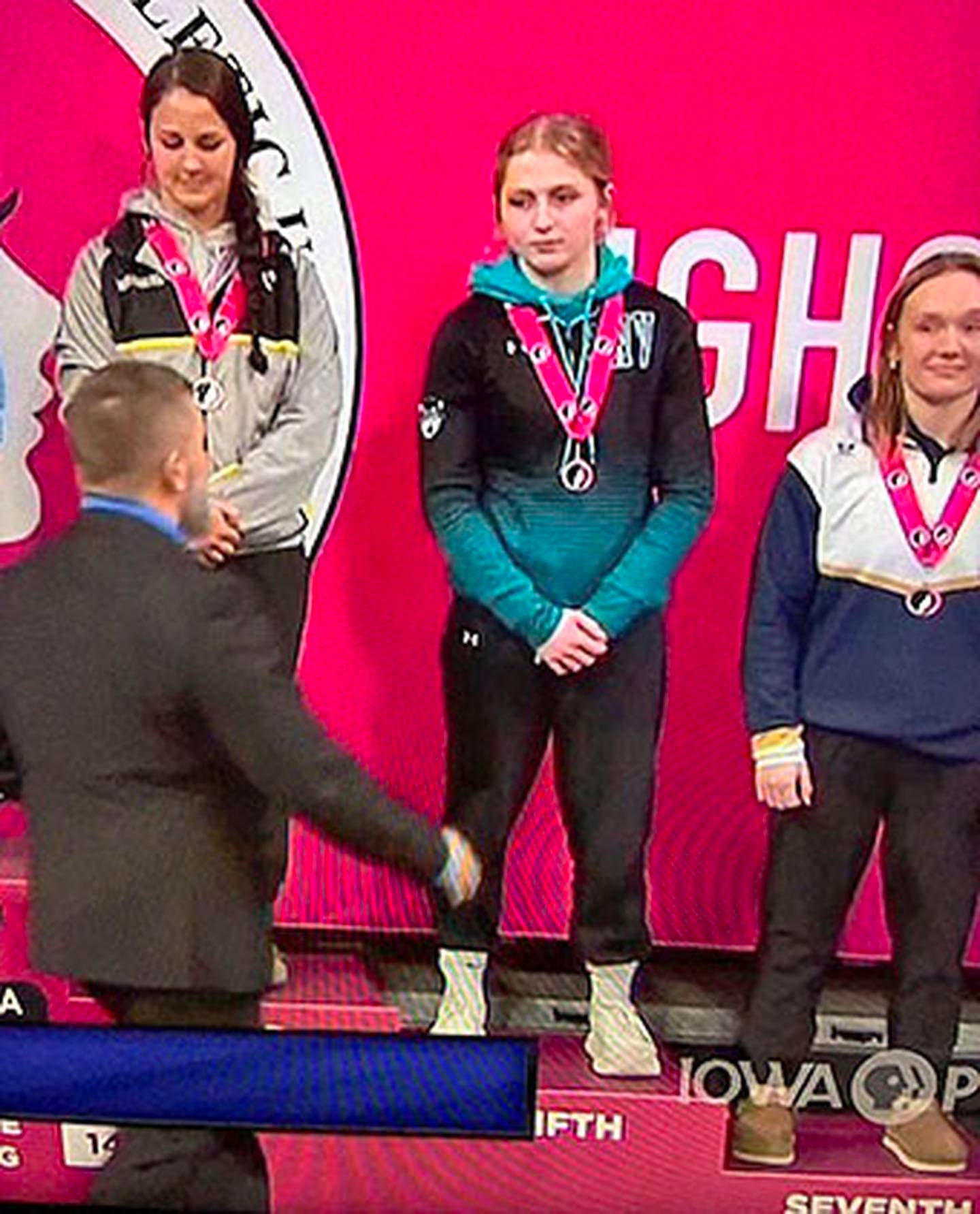 Kenzie Maeder of Southwest Valley (center) earned the fifth-place medal at 145 pounds in Class 1A.