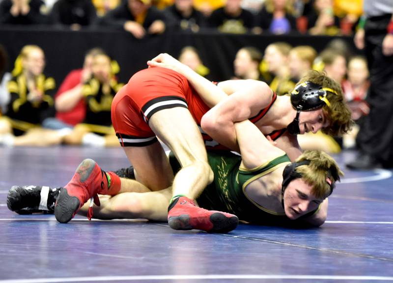 Senior Christian Ahrens (120) works to flip Tanner Paustian of Woodward-Granger. Ahrens won with a pin, advancing to the quarterfinals.