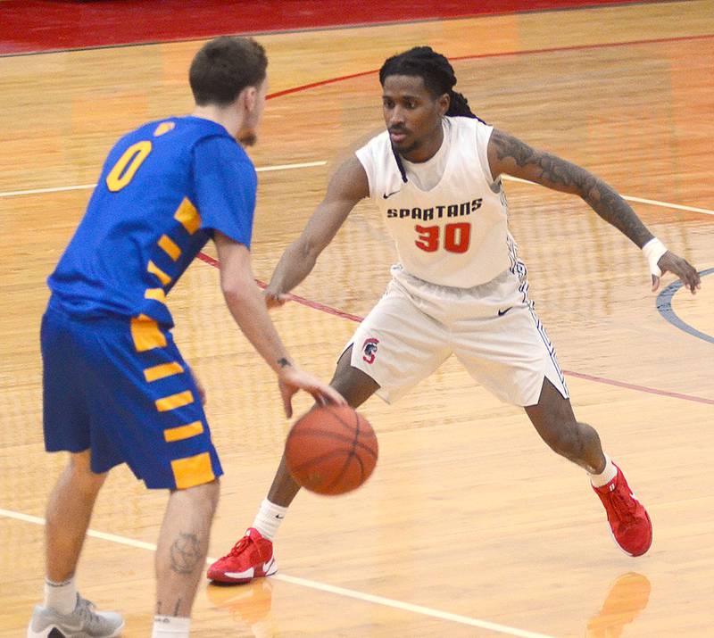 Southwestern's Niko Wilson (30) guards NIACC's Cameron Reigard during Saturday's game.