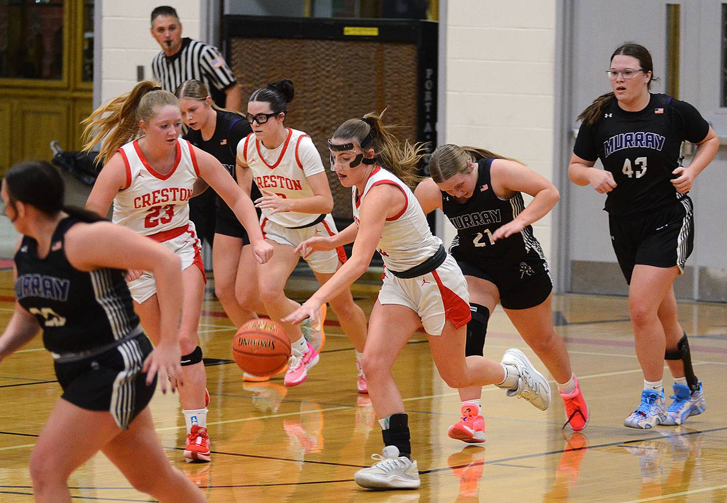 Creston point guard Hollynn Rieck advances the ball in transition against Murray Monday as teammates Brynn Tussey (23) and Braylee Pokorny head upcourt. Rieck had six assists in the 55-22 victory.