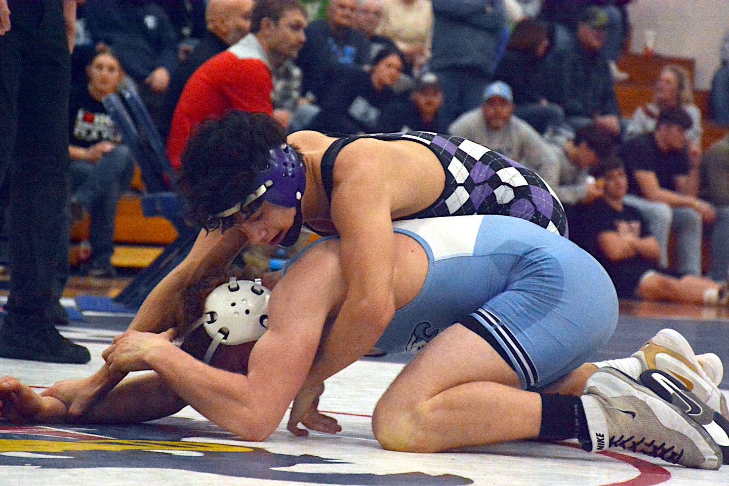 NV senior Keyin Steeve works on top of East Union's Hudson Cox Saturday afternoon in the district tournament at I-35 High School.