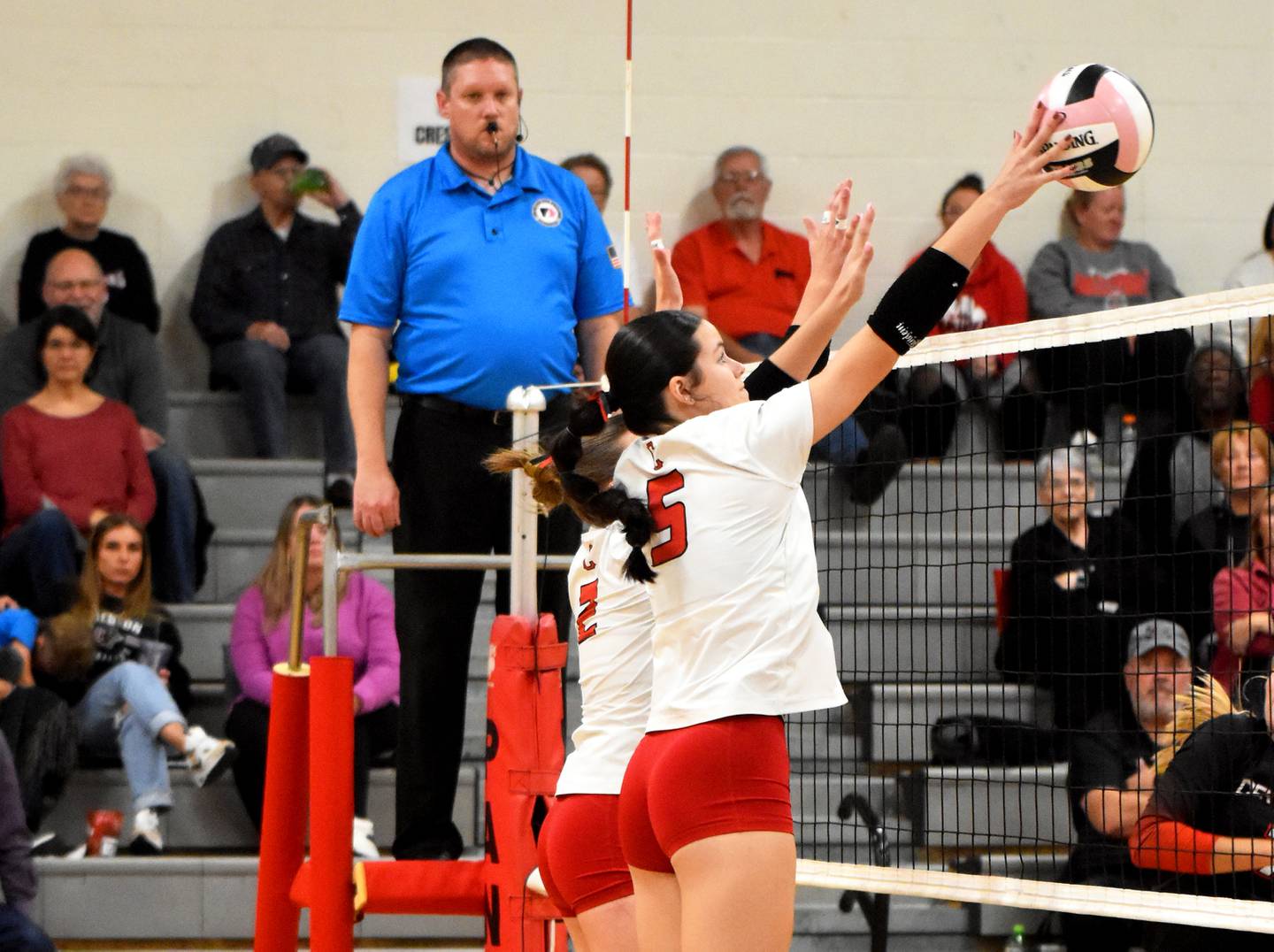 Creston senior Braylee Pokorny gets a hand up for a block against the Big Reds. She had three total in the match.