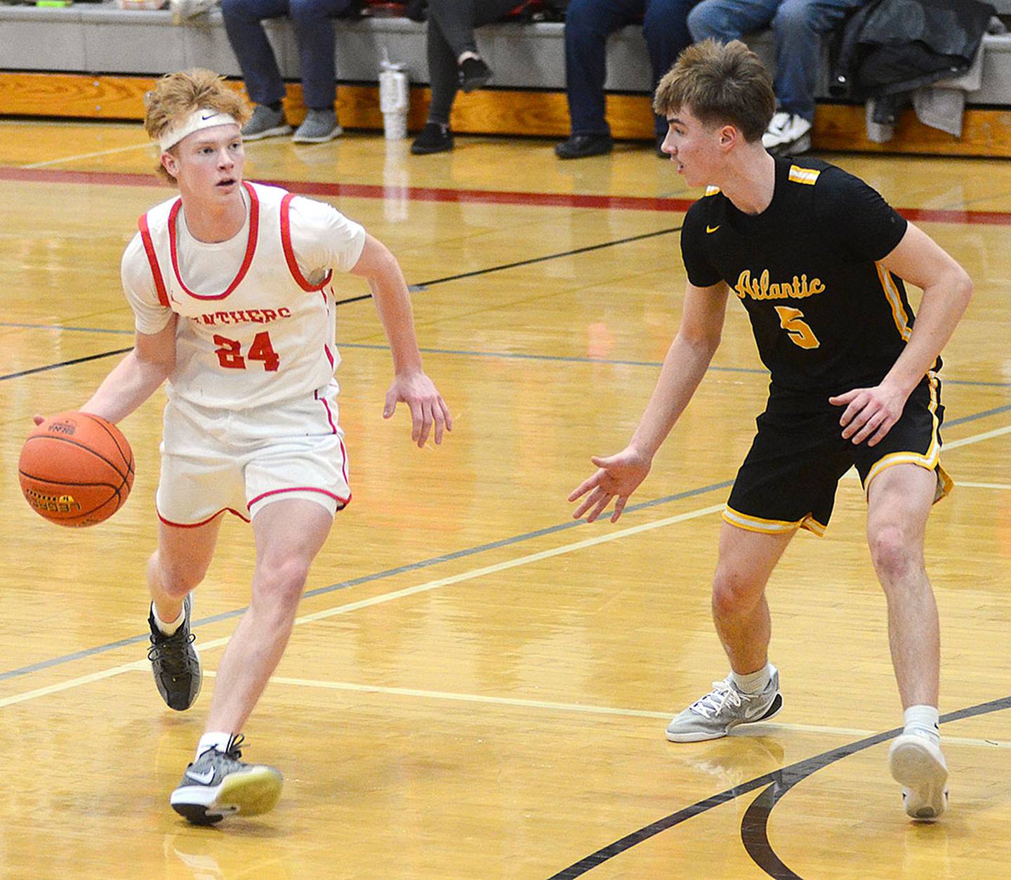Creston guard Tanner Ray dribbles against Atlantic defender Sawyer Tarrell during the fourth quarter of Monday's game. Ray had eight points and six rebounds in the victory.