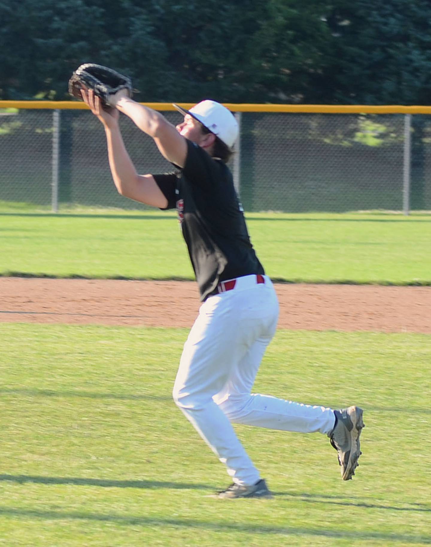 Creston first baseman Mattias Schultes catches an infield pop fly against Kuemper Catholic Wednesday. Schultes made his return from being out with an orbital floor fracture.