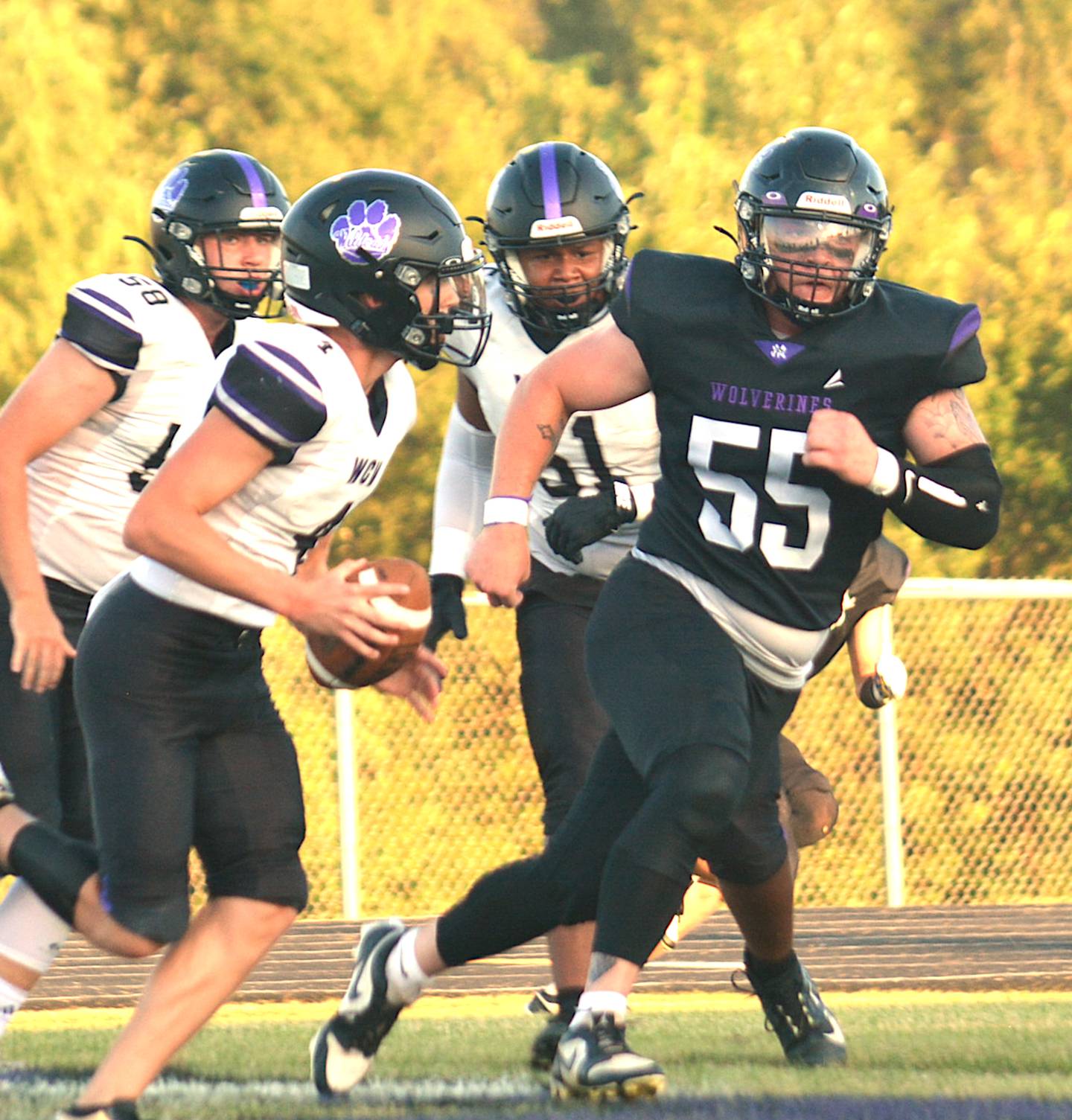 NV/OM senior Ashton Honnold (55) flushes WCV quarterback Colton Lindsay from the pocket in last Friday's football game in Greenfield.