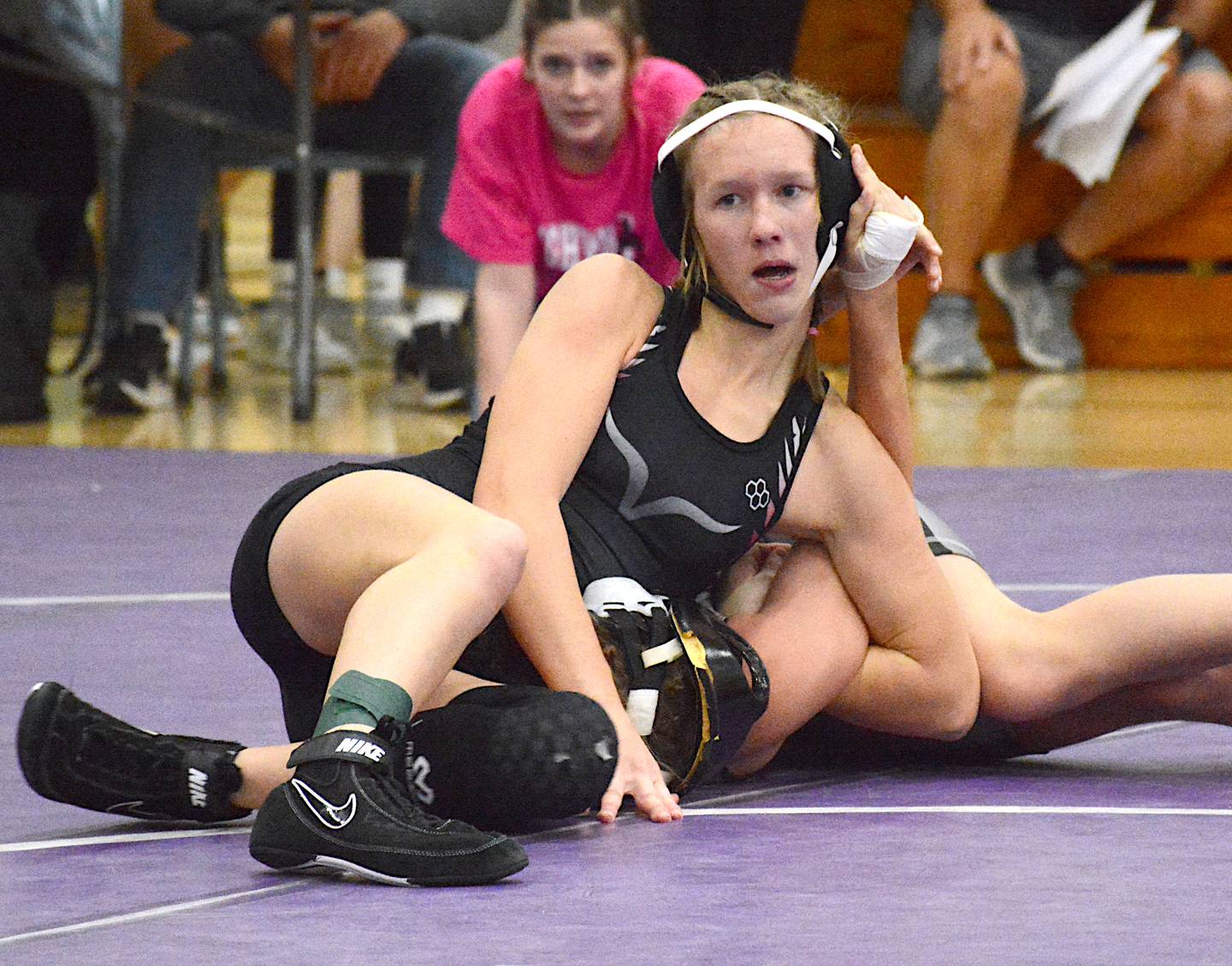 Valkyries junior Jazz Christensen works for a pinning combination in a match at a scramble on the opening night of the girls wrestling season held in Greenfield.