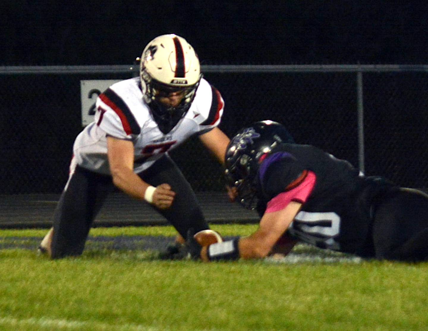 Wolverine senior Parker Schneider dives on a loose ball early in last Friday's game against Mount Ayr.