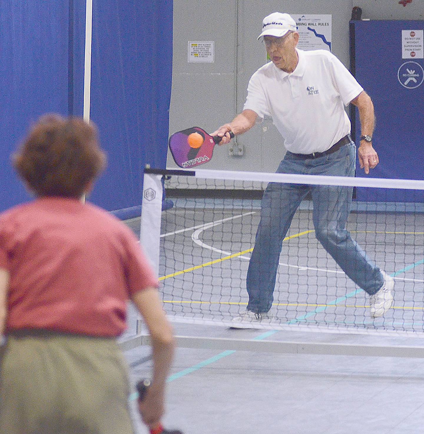 Jerry Thomsen returns a shot during a doubles match at Southern Prairie Family Fitness Center.