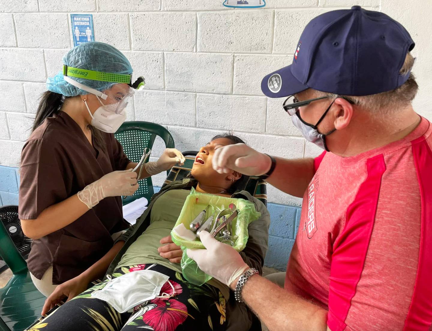 Wayne Hanson assists with a dental procedure in Guatemala.