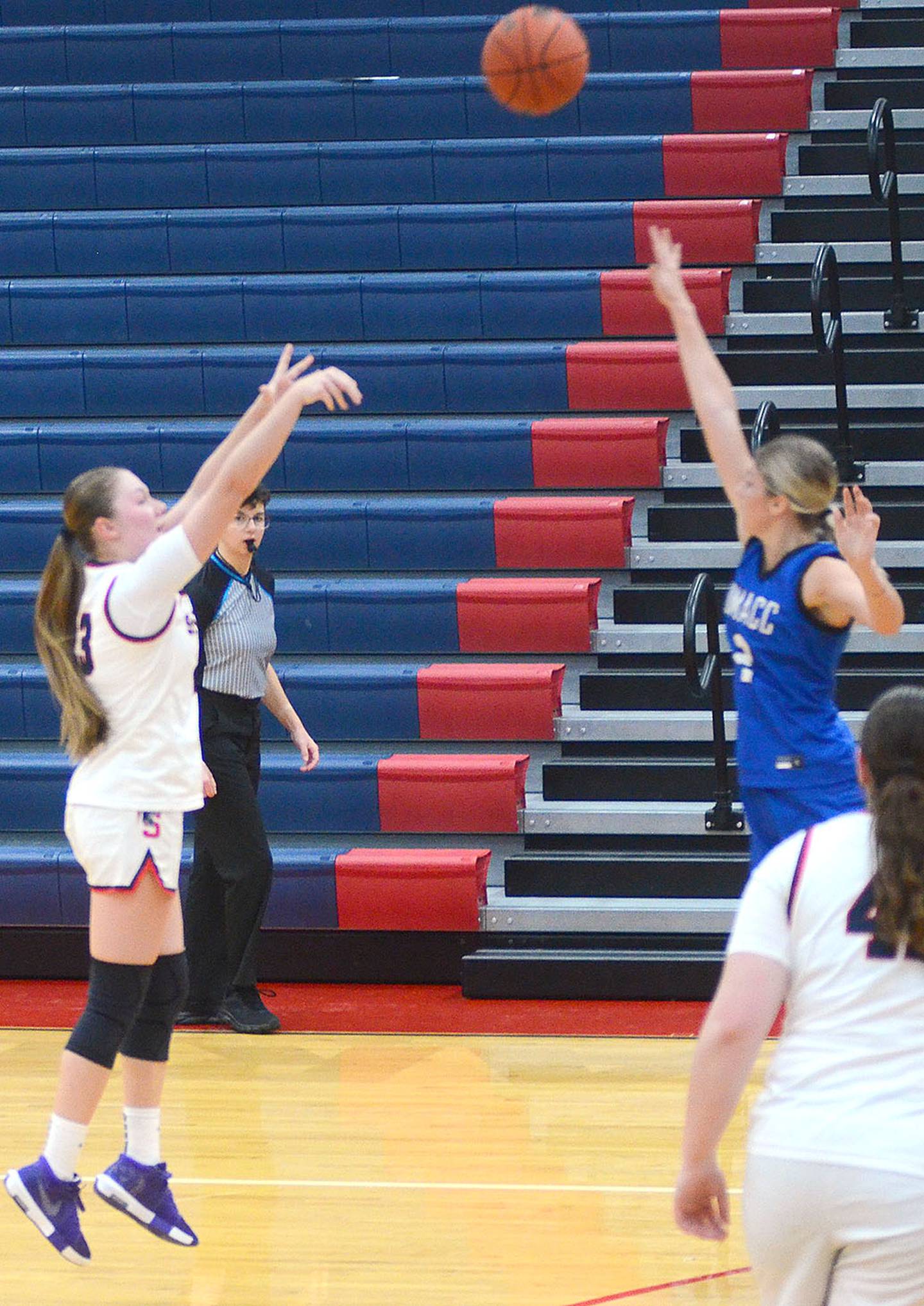 DMACC freshman Jaxy Knight of Mount Ayr (right) contests a shot by Fanine Adgnot of Southwestern during Saturday's game. Adgnot had five points and six rebounds. Knight had three rebounds and one assist for the Bears.