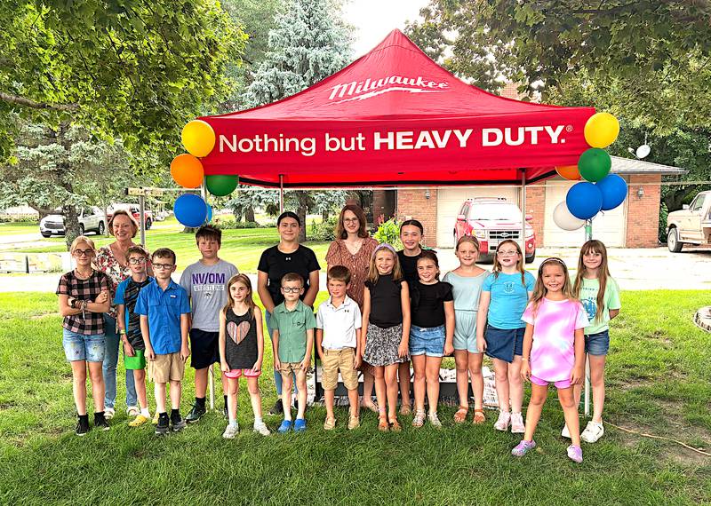 Piano students of Ruth Holan performing last Tuesday in a piano carnival in her front yard in Fontanelle were in front from left, McKenzie Van Horn, Tucker Bigelow, Ryder Noland, Aria Bigelow, Hayes Nolan, James Dreher, Alyse Dreher, Savannah Lee, Millie McIntire, Emersyn Fox, Callie Mensing and Amelia Freeland; back row: Ruth Holan, Reid Steele, Wendy Gutierrez, Allegra Rectenbaugh and Shyanne Lee.