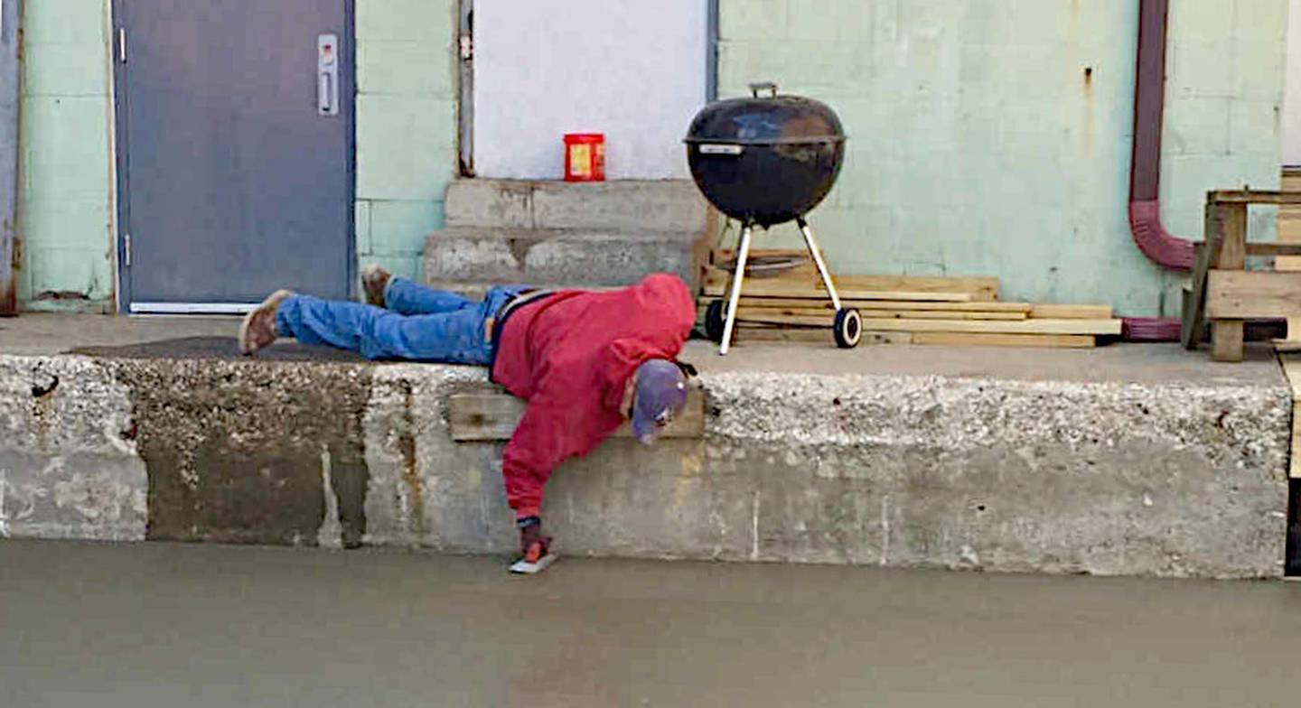 Trevor Paulus works to smooth concrete on a construction project. Paulus typically will try to reduce labor costs for community projects if possible.