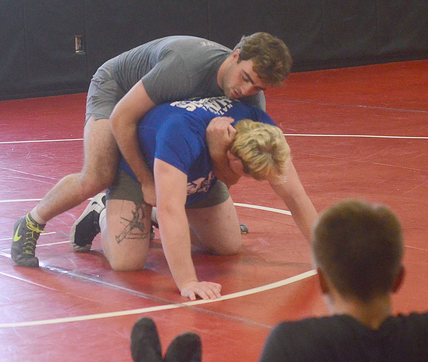 UNK 197-pound wrestler Jackson Kinsella (top) demonstrates a "claw tilt" grip on teammate Crew Howard, UNK's heavyweight.