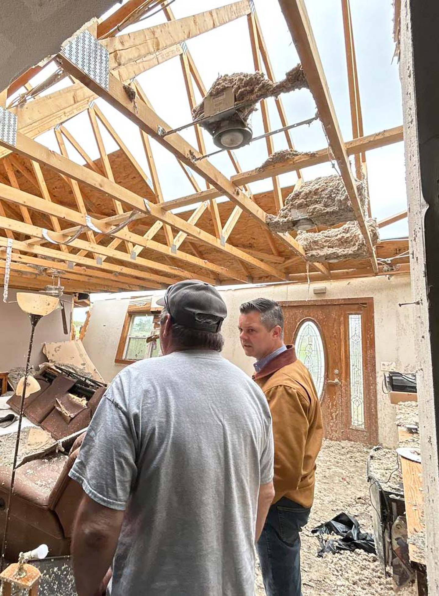 Iowa Congressman Zach Nunn visits a damaged home in Union County Saturday.