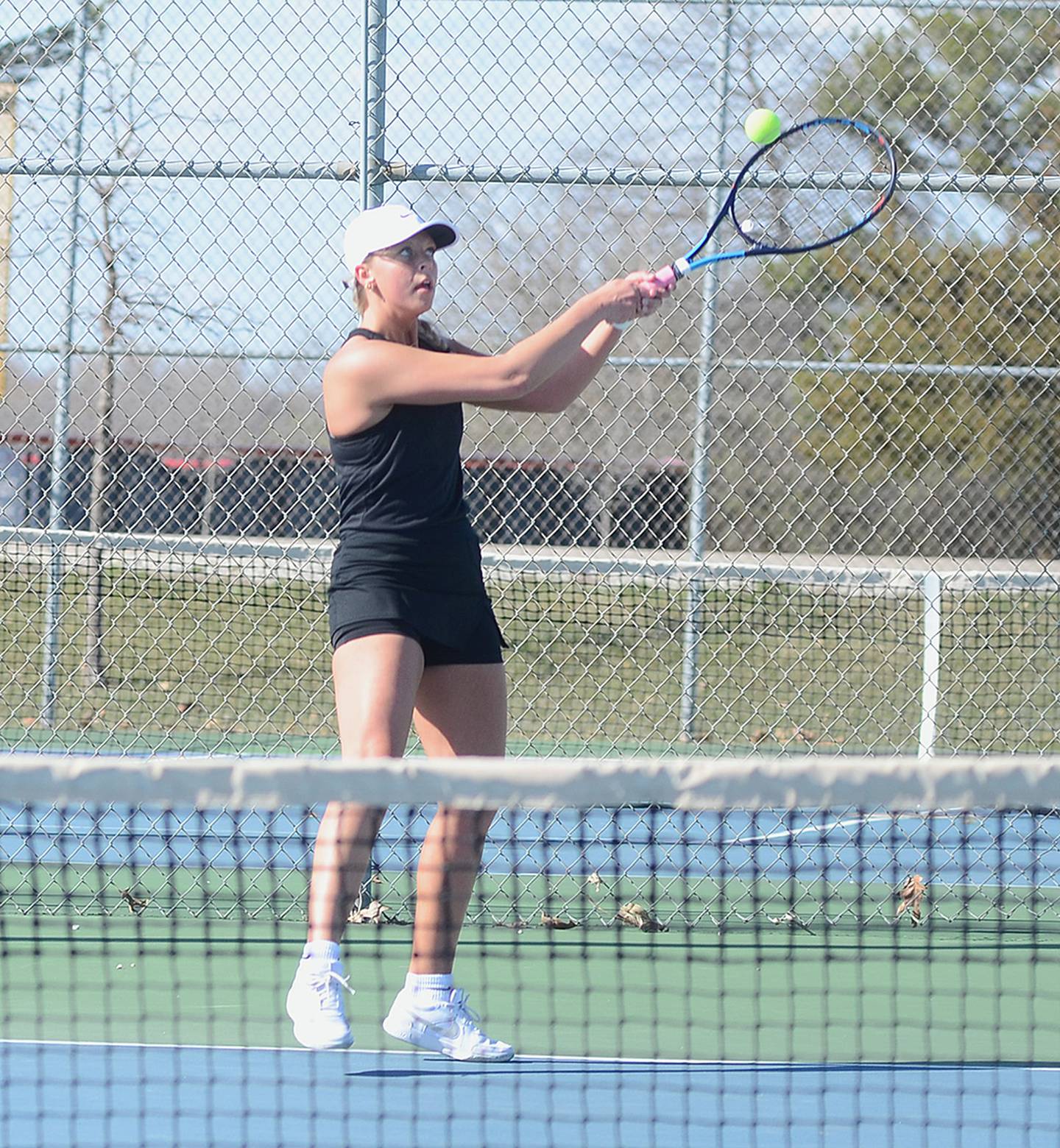 Creston senior Josie Mahan hits a backhand shot near the baseline during her No. 1 singles match Monday. Mahan teamed with freshman Violet Marcus for a key 8-1 win at No. 2 doubles in the team's 6-3 victory.