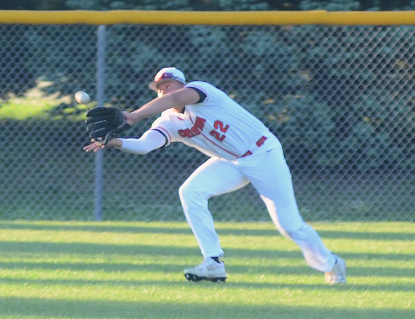 Creston left fielder Brayden Schoon reaches to catch a shallow line drive for a Kuemper Catholic out in the second game of Wednesday's doubleheader.