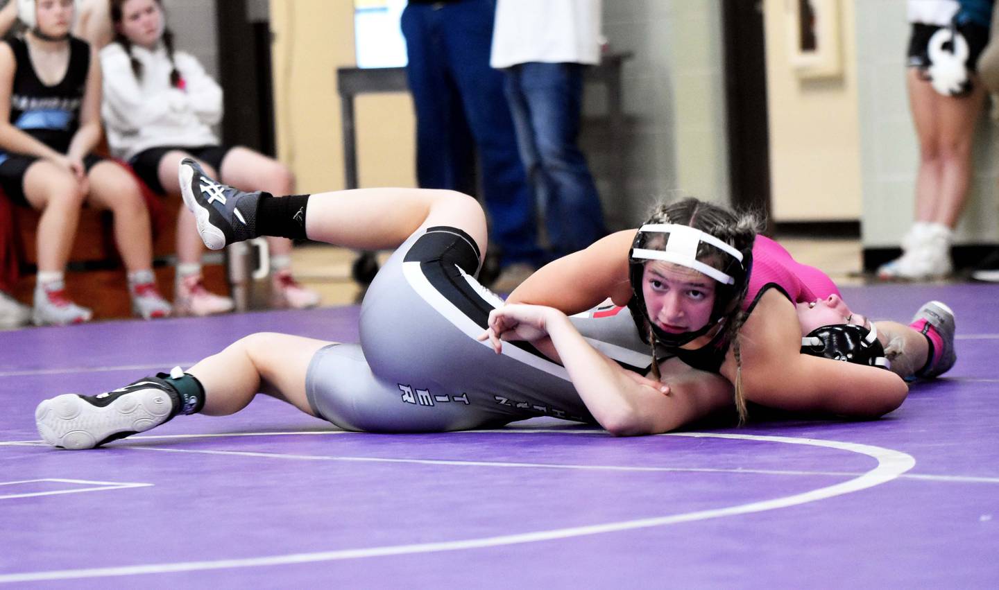 Alainah Galanakis (125) holds Emma Hill of Southern Tier to the mat in the semifinals. Galanakis went on to win her weight class.