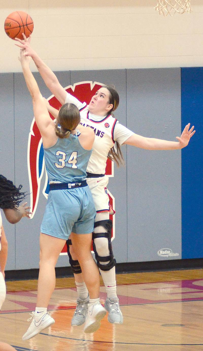 Southwestern sophomore Mikayla "Gracie" Hearon blocks a shot by Lainey Maehl of Iowa Central during Saturday's game. Hearon led the Spartans with 17 points and five rebounds in the loss.