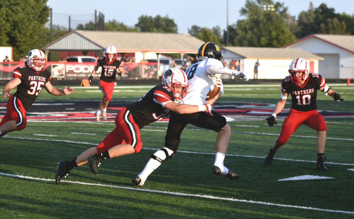 Creston senior Austin Evans gets the tackle on senior wide receiver Kade White. Coming in to assist are Will Bollinger (35), McCoy Haines (15) and Dillon Starlin (10).