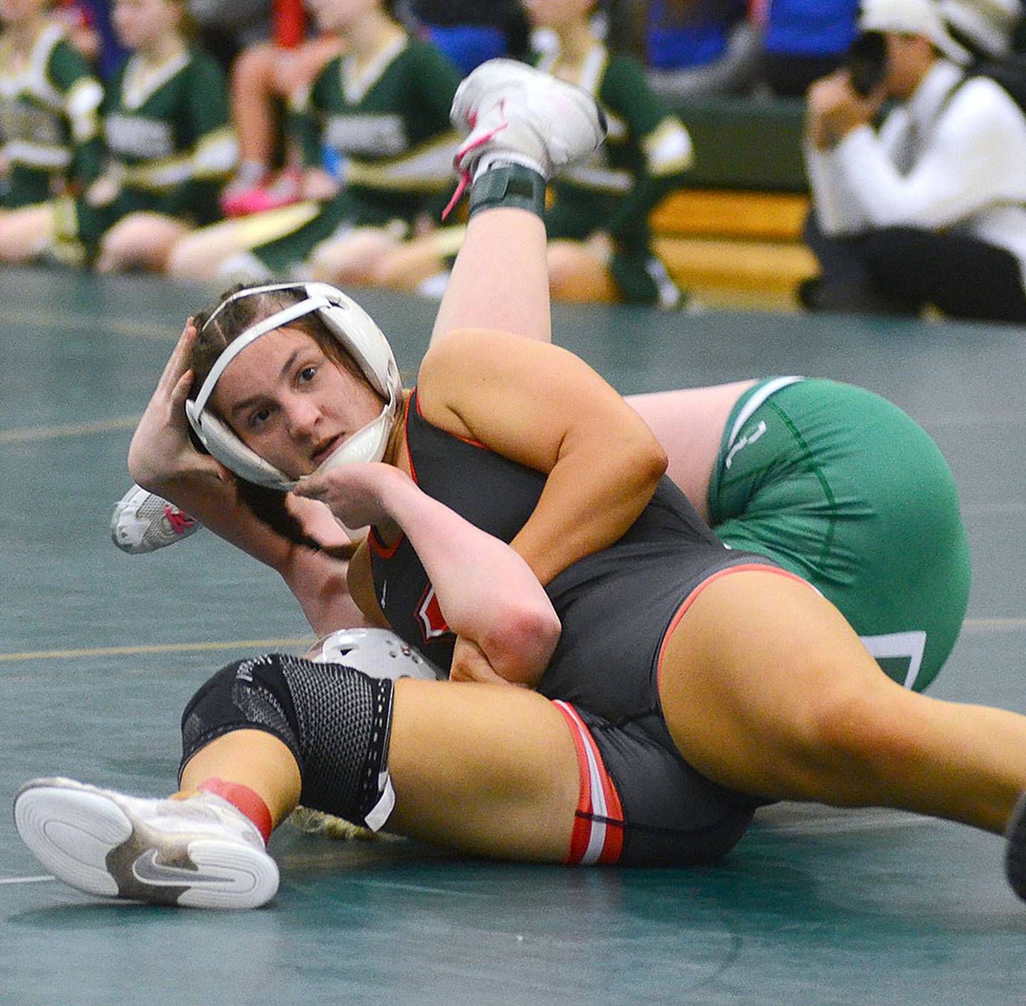 Creston's Grace Keeler looks to her coaches while controlling her semifinal match against Abby Beier of Osage. Keeler won by fall on the way to placing second.