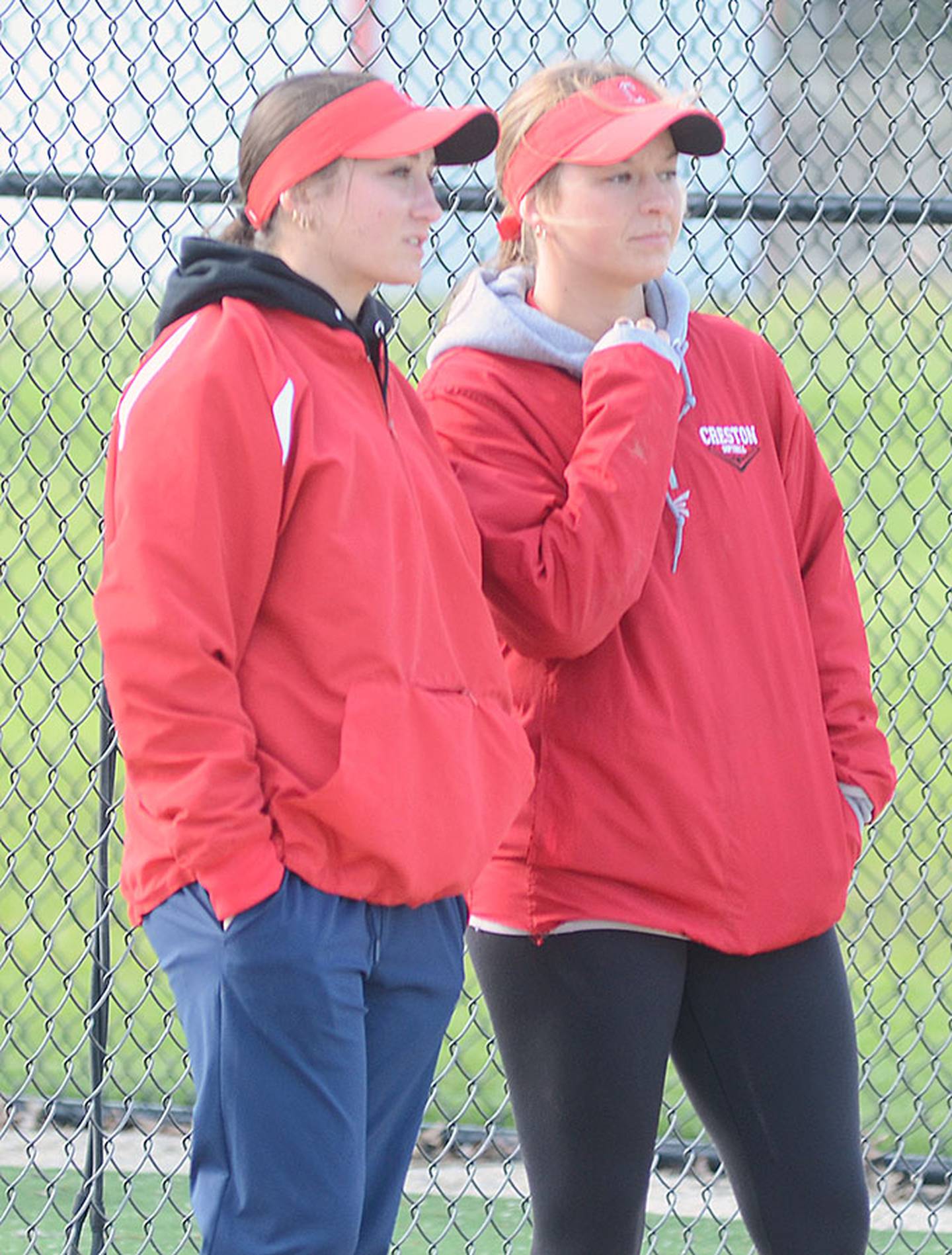 Head coach Gracie Hagle (right) confers with assistant coach Kaitlyn Mitchell during a practice. Mitchell was a catcher for East Union and Southwestern Community College.