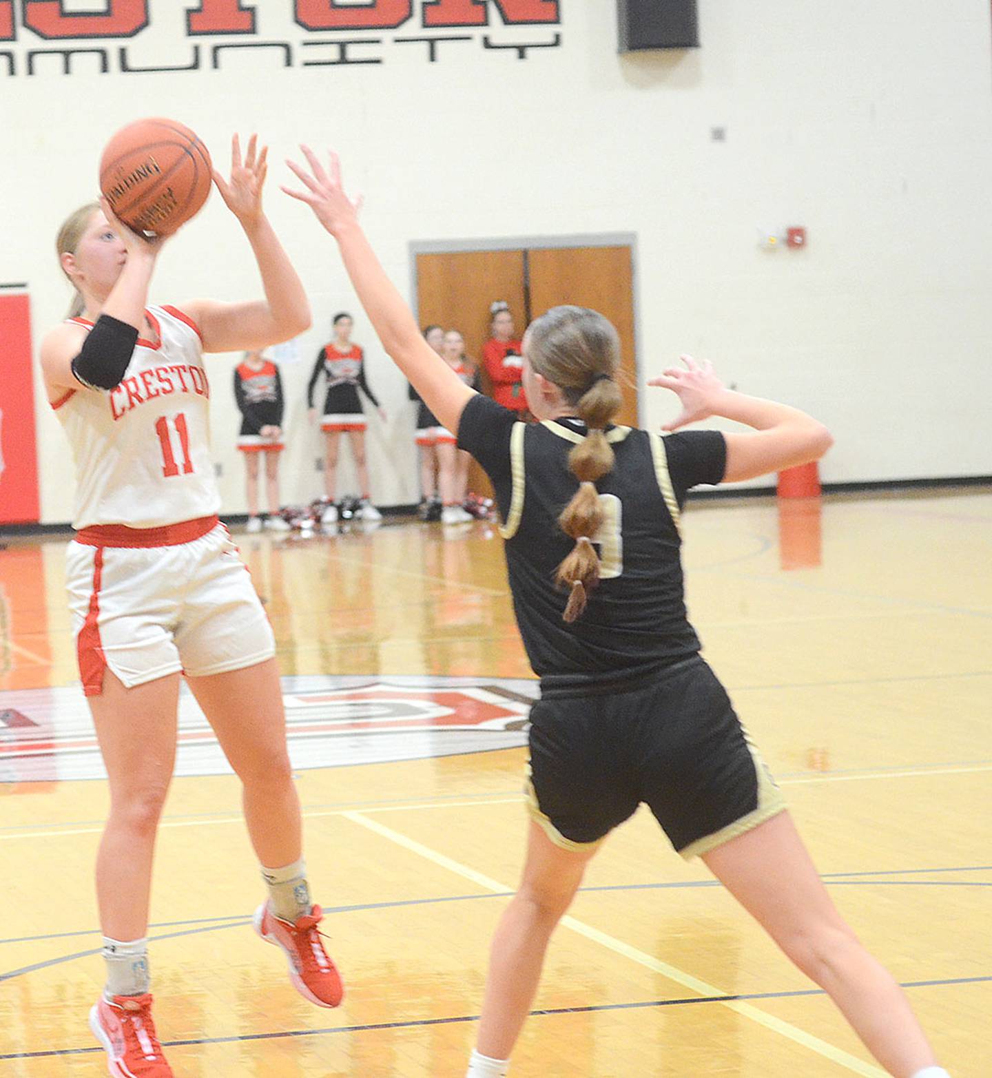 Creston's Brynn Tussey (11) takes a shot near the free throw line against Glenwood Friday. Tussey had three points and two rebounds in the loss.