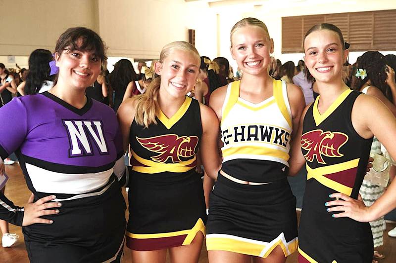 Gracelyn Lewis (far left) with two Ankeny cheerleaders and one from Emmetsburg during a recent camp in Honolulu, Hawaii.