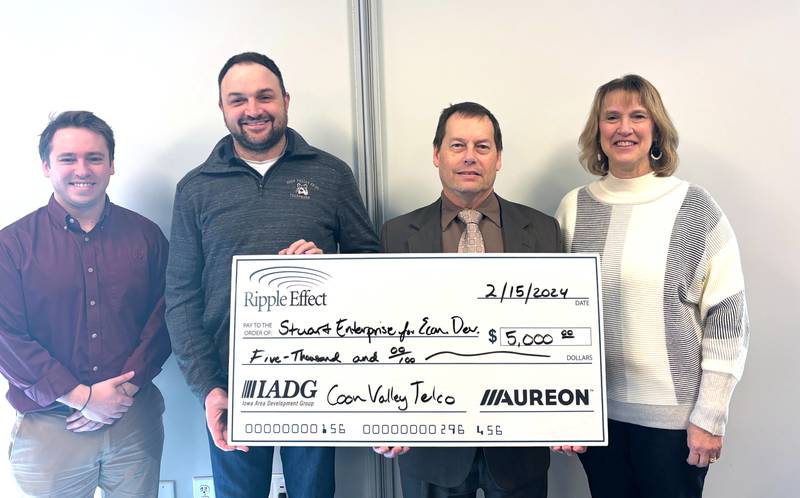 Matt Funk with Stuart Enterprise for Economic Development (SEED), third from left, receives a $5,000 check from Coon Valley Telco. From left are Ethan Pitt, Ripple Effect Program Director with Iowa Area Development Group; Justin Schneider with Coon Valley Telephone, Funk with SEED; and Brenda Dudley with Midwest Partnership.