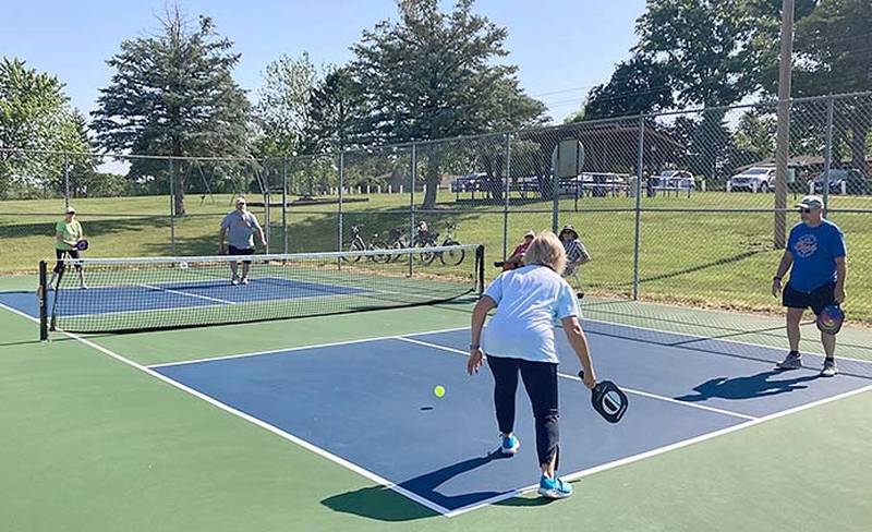 Community members gather to play pickleball at the multi-sport courts at McKinley Park.